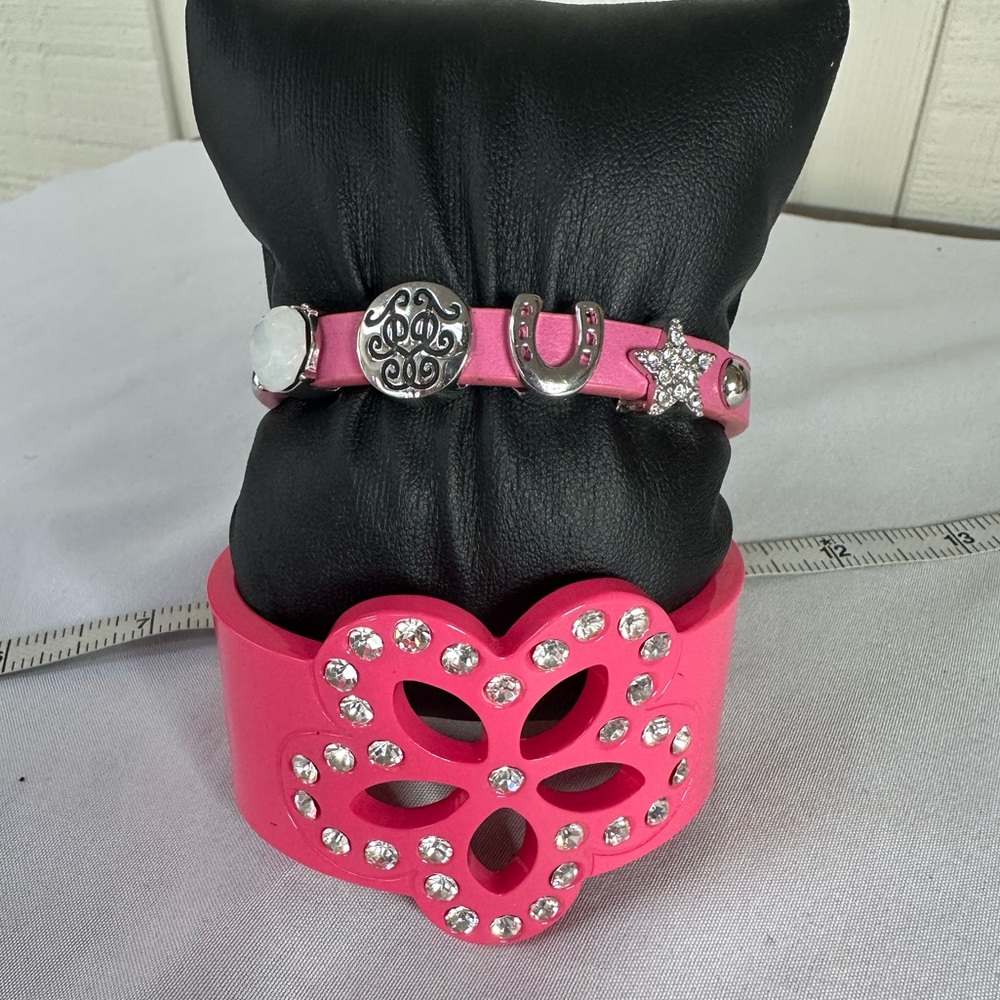 Two pink bracelets with rhinestones and charms